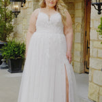 Plus-size bride wearing the Michelle Bridal MB2613 Florence A-line wedding gown with double beaded straps, a sweetheart neckline with nude mesh insert, floral appliqués and 3D organza flowers, and a Chantilly lace skirt with tulle overlay and a subtle slit.