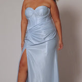 Sexy fitted pastel plus size prom dress by Tease Prom. Style TE2528. Strapless  bodice with assymetrical basque waistline. Exposed corset boning and bustier bodice is fully lined.  Ruchsing and knot detail at the waistline and high slit with sweep train on a fitted skirt.  Tease Prom style TE2528 is available in lavender purple or sky blue in plus sizes 14-24. 