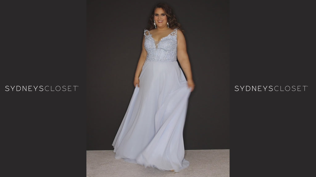Sydney’s Closet SC7351 in light blue and light purple. Full A-line silhouette with a deep V-neckline and lace covered double straps. Chiffon, A-line skirt with a slit, and lace covered bodice with exposed boning. A natural waistline and partially lined bodice
