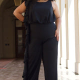 CE2014 by Sydney's Closet french crepe fabric jumpsuit with flounce on side of bodice and pant with center back zipper and scoop neckline, bra friendly straps and sleeveless available in red, black and ivory.