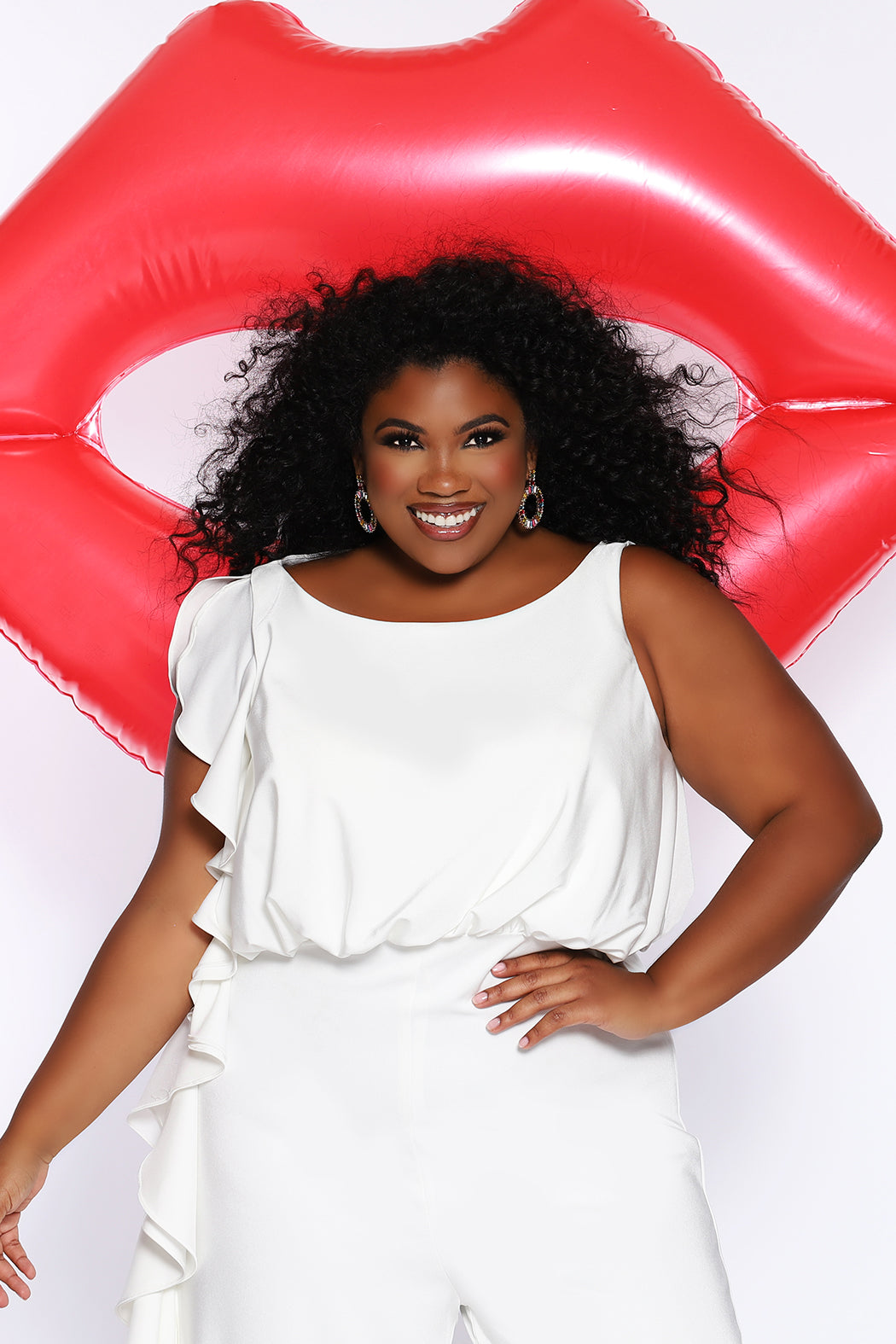 CE2014 by Sydney's Closet french crepe fabric jumpsuit with flounce on side of bodice and pant with center back zipper and scoop neckline, bra friendly straps and sleeveless available in red, black and ivory.