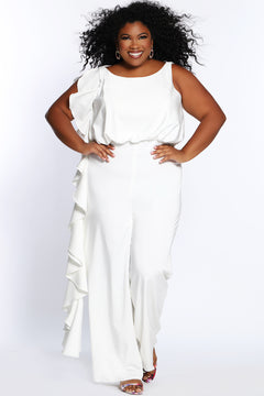 CE2014 by Sydney's Closet french crepe fabric jumpsuit with flounce on side of bodice and pant with center back zipper and scoop neckline, bra friendly straps and sleeveless available in red, black and ivory.