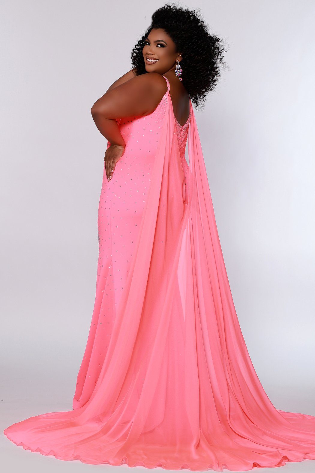 Johnathan Kayne for Sydney's Closet princess line slim silhouette with deep v neckline all over ab hotfix stones and center back zipper available in deep red, hot coral and white ice Maverick Pageant Gown JK2218