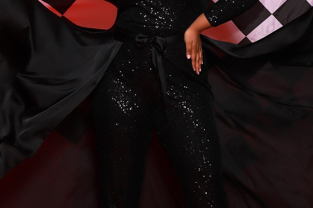 Johnathan Kayne for Sydney's Closet jumpsuit with v neckline and detatchable charmeuse overskirt and long sleeves made of stretch sequin fabric available in firecracker and jet Matador Pageant Jumpsuit JK2220