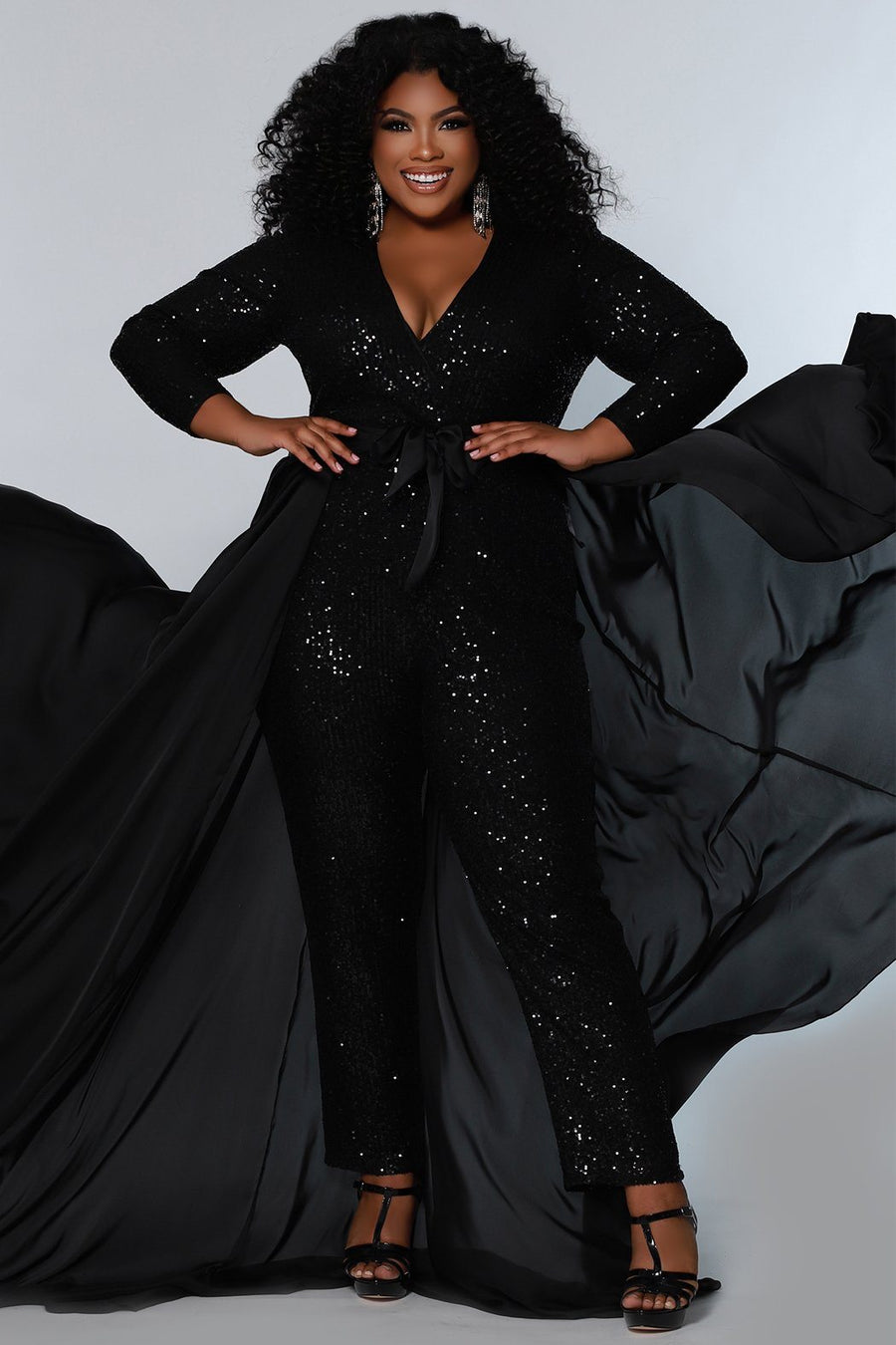 Johnathan Kayne for Sydney's Closet jumpsuit with v neckline and detatchable charmeuse overskirt and long sleeves made of stretch sequin fabric available in firecracker and jet Matador Pageant Jumpsuit JK2220