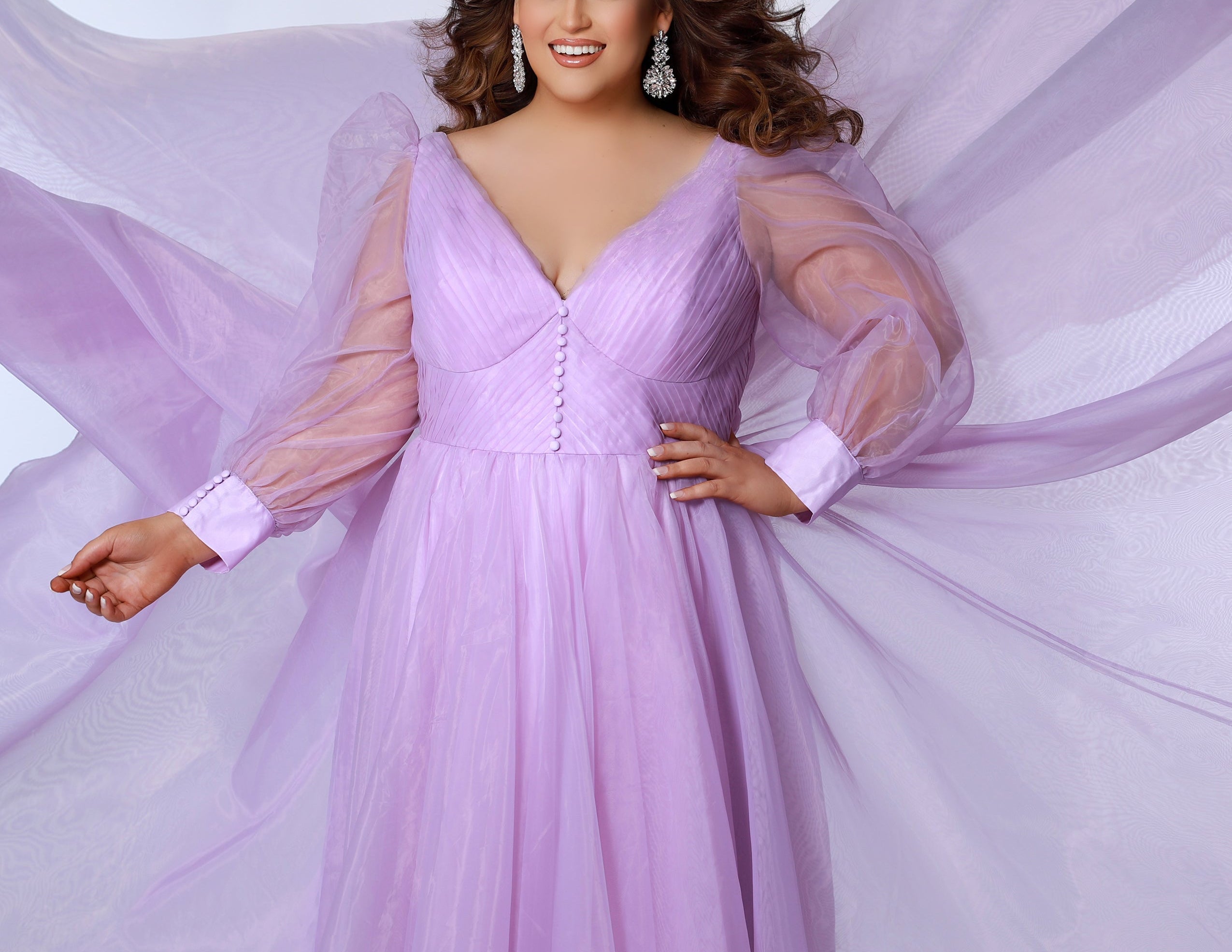 JK2317 plus size organza evening gown.  V-neckline, puff sleeves with cuff, pleated organza bodice and sweep train. Available in lilac purple, sky blue and diamond white. Johnathan Kayne for Sydney's Closet. Photographer Georgina Vaughan 