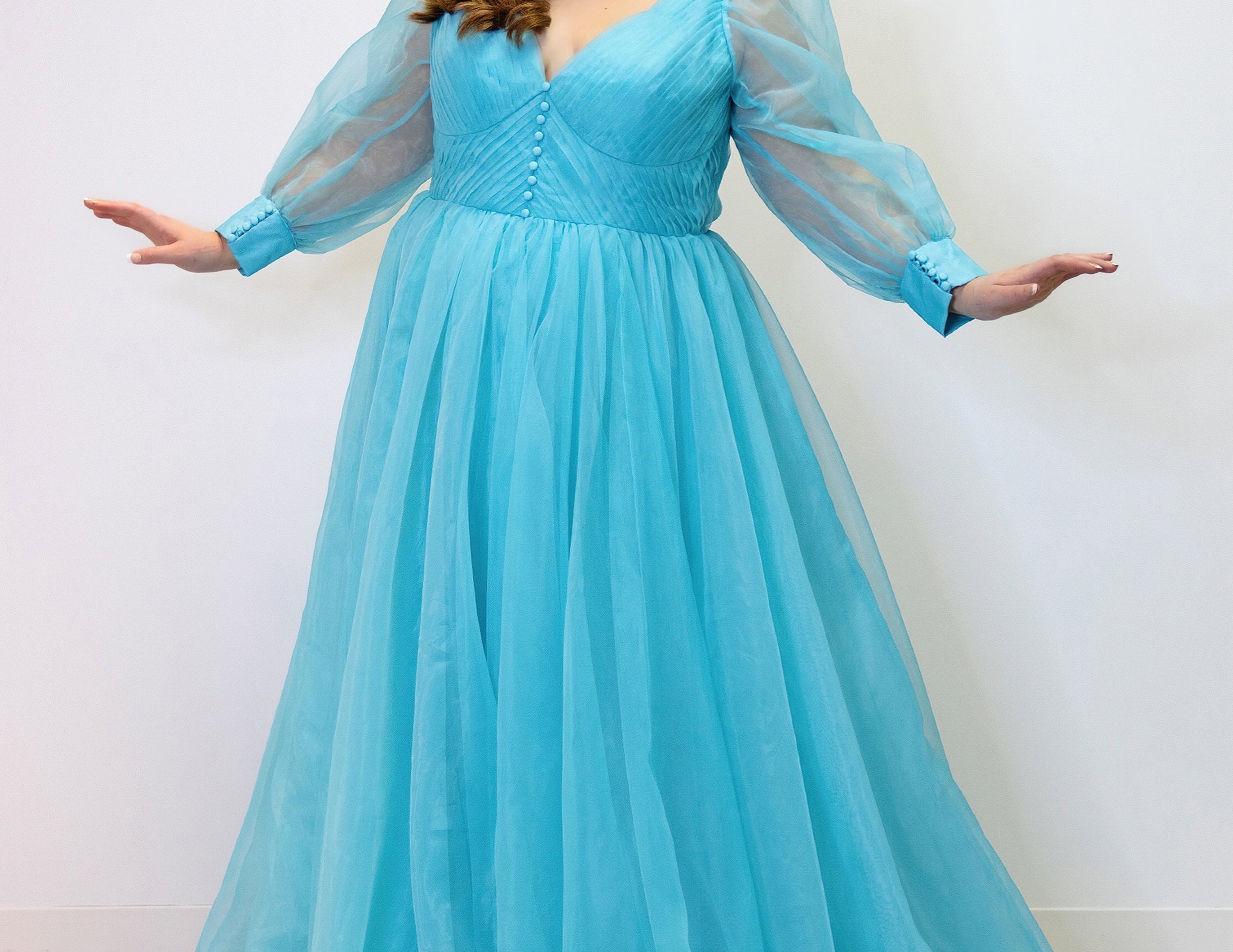 JK2317 plus size organza evening gown.  V-neckline, puff sleeves with cuff, pleated organza bodice and sweep train. Available in lilac purple, sky blue and diamond white. Johnathan Kayne for Sydney's Closet.