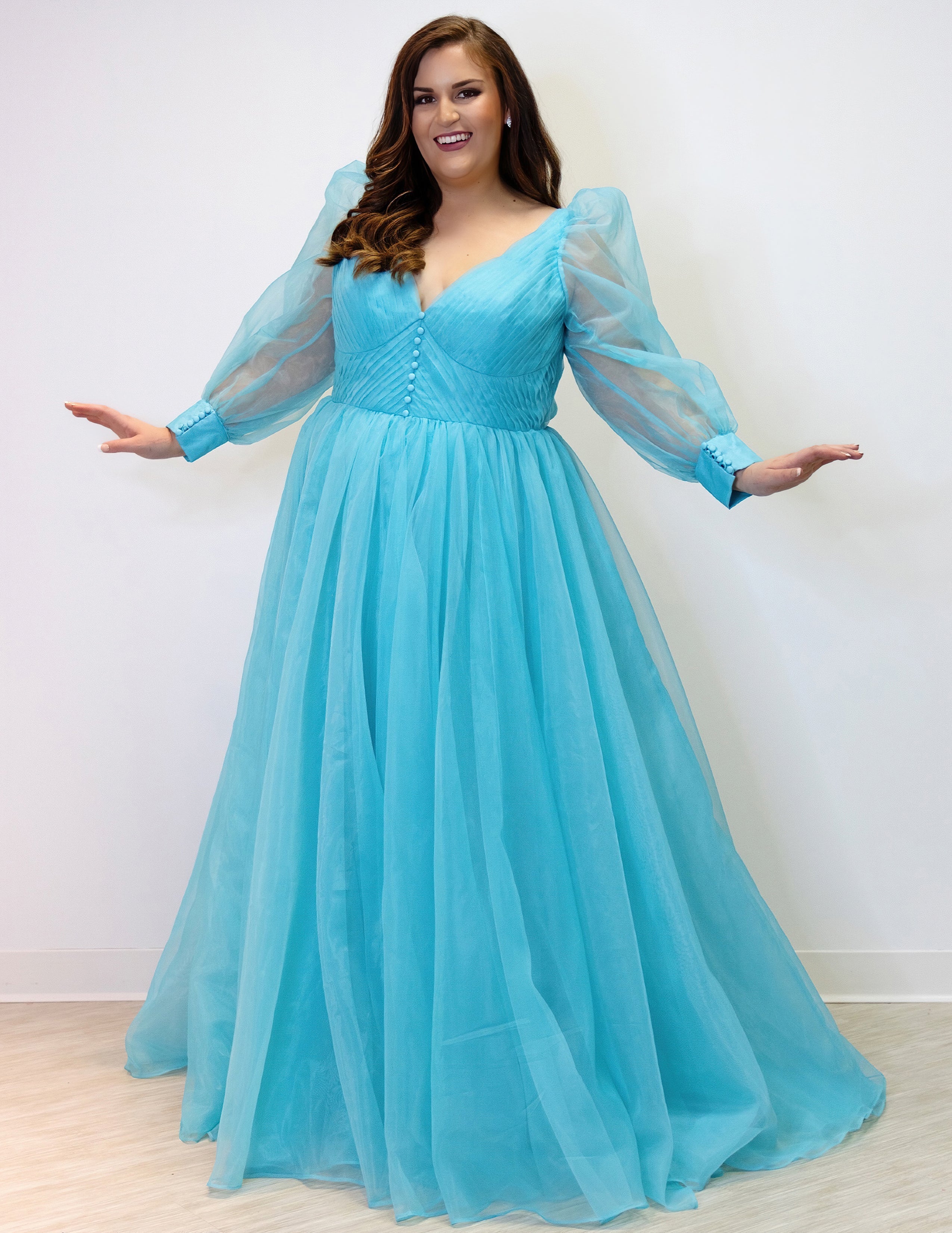 JK2317 plus size organza evening gown.  V-neckline, puff sleeves with cuff, pleated organza bodice and sweep train. Available in lilac purple, sky blue and diamond white. Johnathan Kayne for Sydney's Closet.