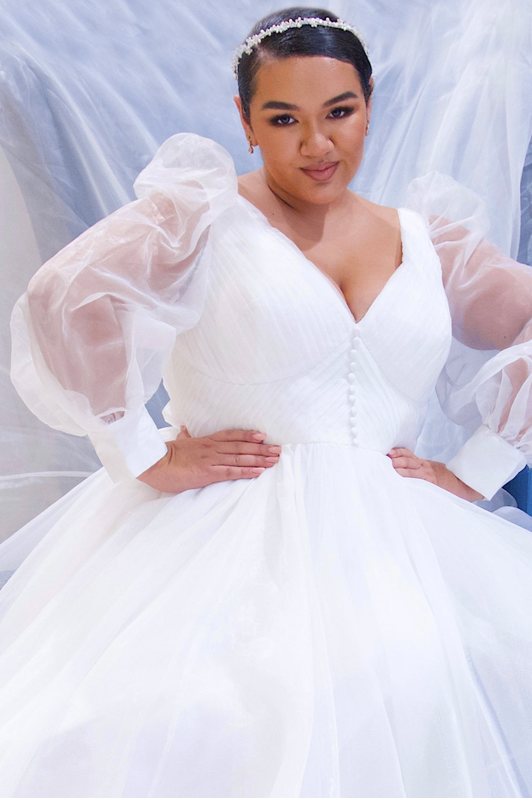 JK2317 plus size organza wedding gown.  V-neckline, puff sleeves with cuff, pleated organza bodice and sweep train. Available in lilac purple, sky blue and diamond white. Johnathan Kayne for Sydney's Closet.