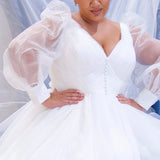 JK2317 plus size organza wedding gown.  V-neckline, puff sleeves with cuff, pleated organza bodice and sweep train. Available in lilac purple, sky blue and diamond white. Johnathan Kayne for Sydney's Closet.