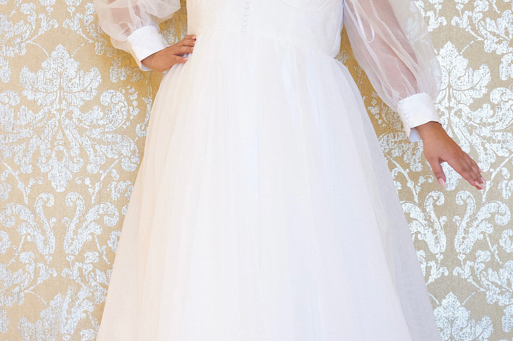 JK2317 plus size organza wedding gown.  V-neckline, puff sleeves with cuff, pleated organza bodice and sweep train. Available in lilac purple, sky blue and diamond white. Johnathan Kayne for Sydney's Closet.