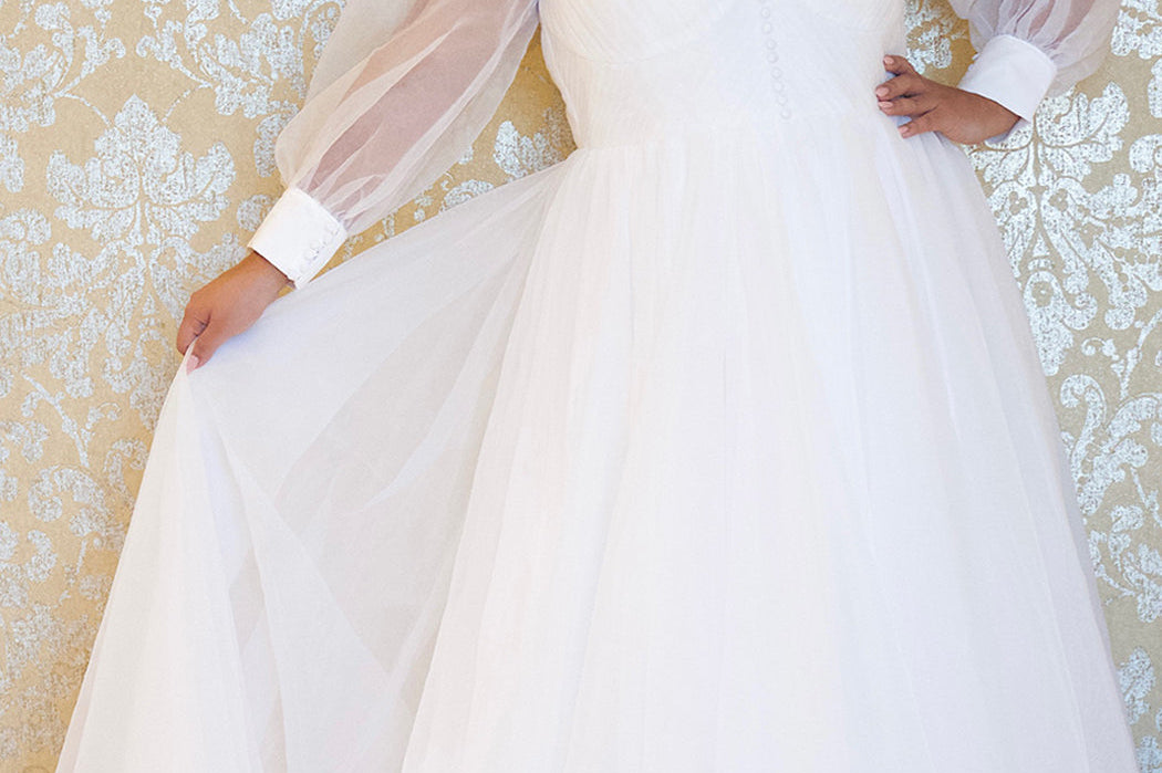 JK2317 plus size organza wedding gown.  V-neckline, puff sleeves with cuff, pleated organza bodice and sweep train. Available in lilac purple, sky blue and diamond white. Johnathan Kayne for Sydney's Closet.