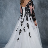 MB2010 plus size bridal gown with deep V-neckline and illusion mesh sleeves are embellished with intricate lace appliques. Full ball gown tulle skirt and lace-up back with modesty panel.