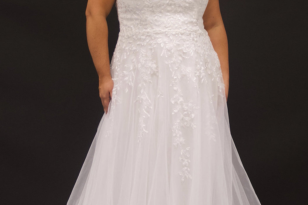 Michelle Bridal Style MB2301 available in sand or ivory. Plus size A-line wedding gown with modern leaf lace, decorative straps on the back bodice and long train. Only sold in stores. 