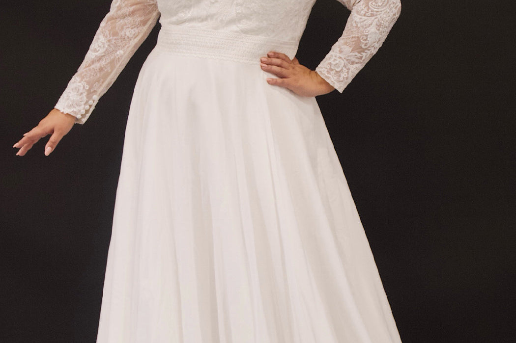 Michelle Bridal plus size wedding gown.  Chiffon skirt, long train, V-neckline, long sleeves, elegant lace and detachable ruffle cuff at the wrist.  Available in ivory/nude or ivory/ivory. Only sold in stores Style MB2319.