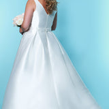 SC5229 a-line bridal gown with plunging V-neckline, bra-friendly straps, pleated skirt with pockets and a sweep train; simple satin plus size wedding gown by Sydney's Closet with pockets