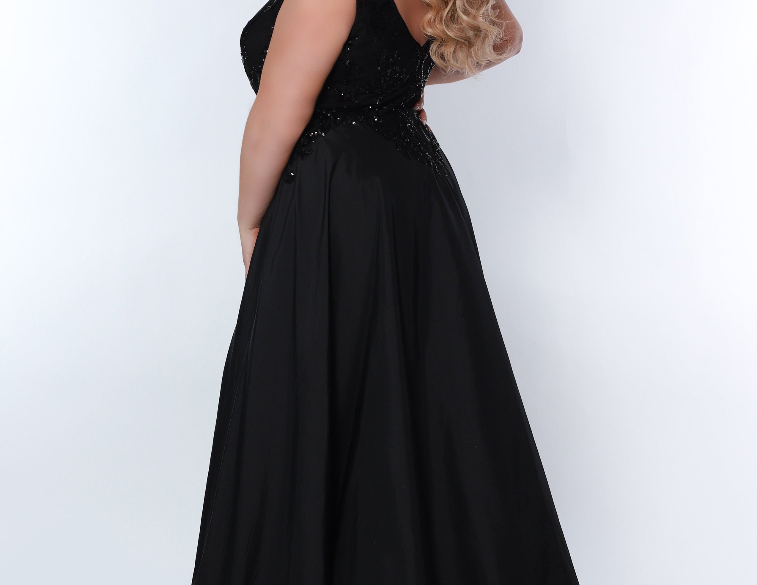 Sydney’s Closet SC7341 Black.  Slim/Fitted silhouette, deep V-neckline and bra-friendly straps. Natural waistline, sequins on net. Mid-thigh skirt with attached charmeuse overskirt. Center  back zipper. 