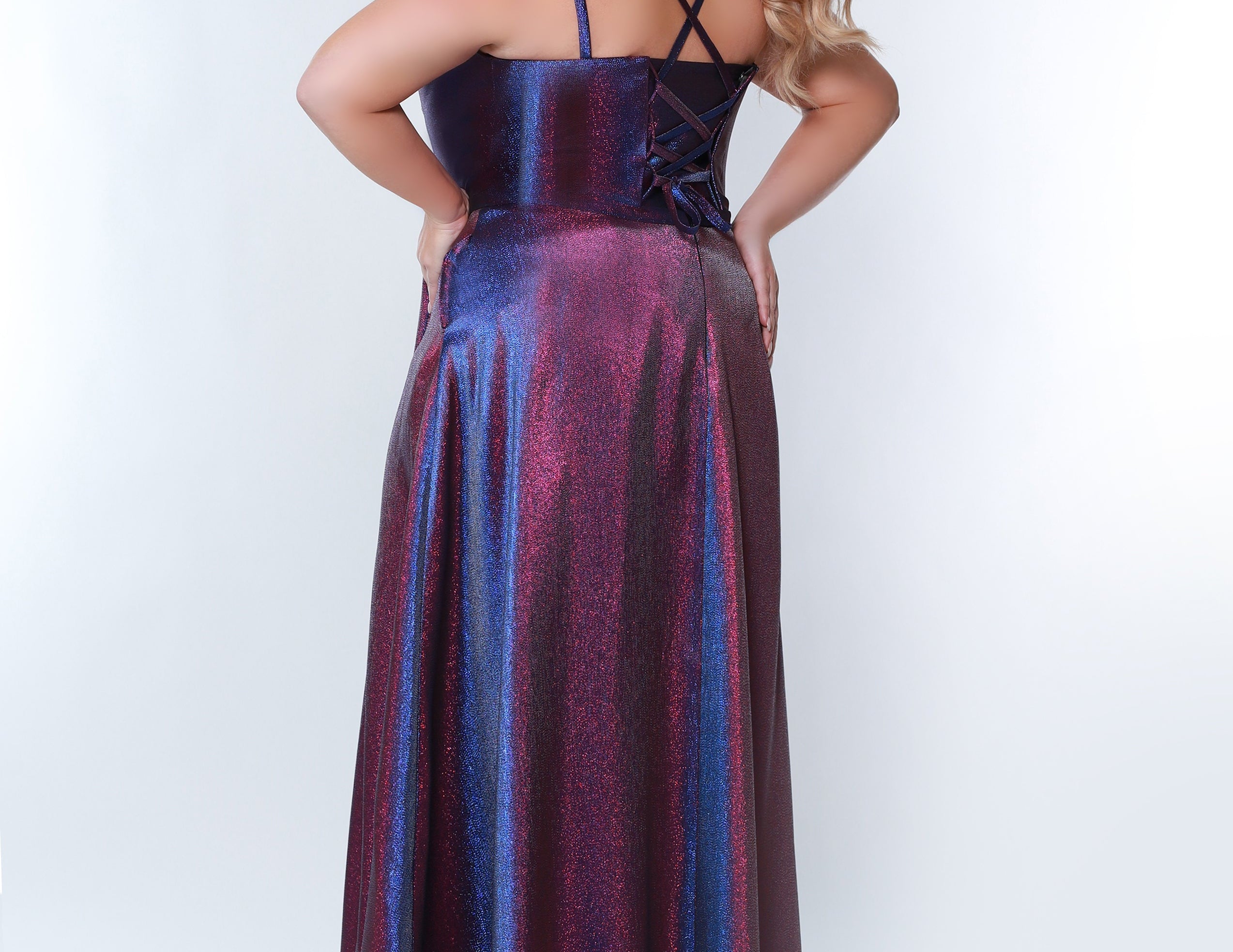 Sydney’s Closet SC7344  Shimmer satin in purple. A-line silhouette, double straps and a scoop neckline. Natural waist, lace up back with modesty panel. A-line skirt with pockets and left leg slit. 