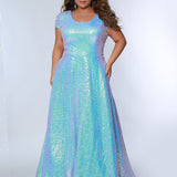 Sydney’s Closet SC7348 in light blue. A-line silhouette with a scoop neckline and cap sleeves. Multidimensional sequins, offered in light blue, purple and peacock green. Has a natural waistline, A-line skirt with pockets, and a horsehair hem. 