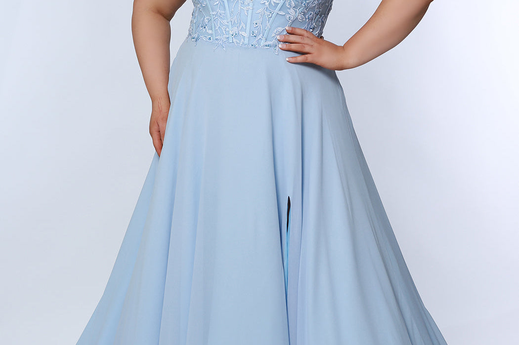 Sydney’s Closet SC7351 in light blue. Full A-line silhouette with a deep V-neckline and lace covered double straps. Chiffon, A-line skirt with a slit, and lace covered bodice with exposed boning. A natural waistline and partially lined bodice