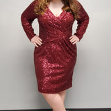 Knee length sequin dress with deep V-neckline, pleated bodice and sleeves. Skirt with side pleats and center-back zipper.