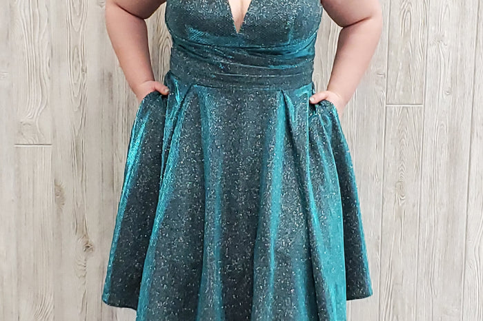 Deep V-neckline, bra-friendly straps and pleated waistline in a shimmering stretch metallic fabric. Knee length full A-line skirt and center-back zipper.