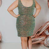 SC8110 Sydney's Closet plus size short sequin party dress. Ruched bodice, , deep V-neckling and slit. Multi dimensional sequins in green, blue or red.