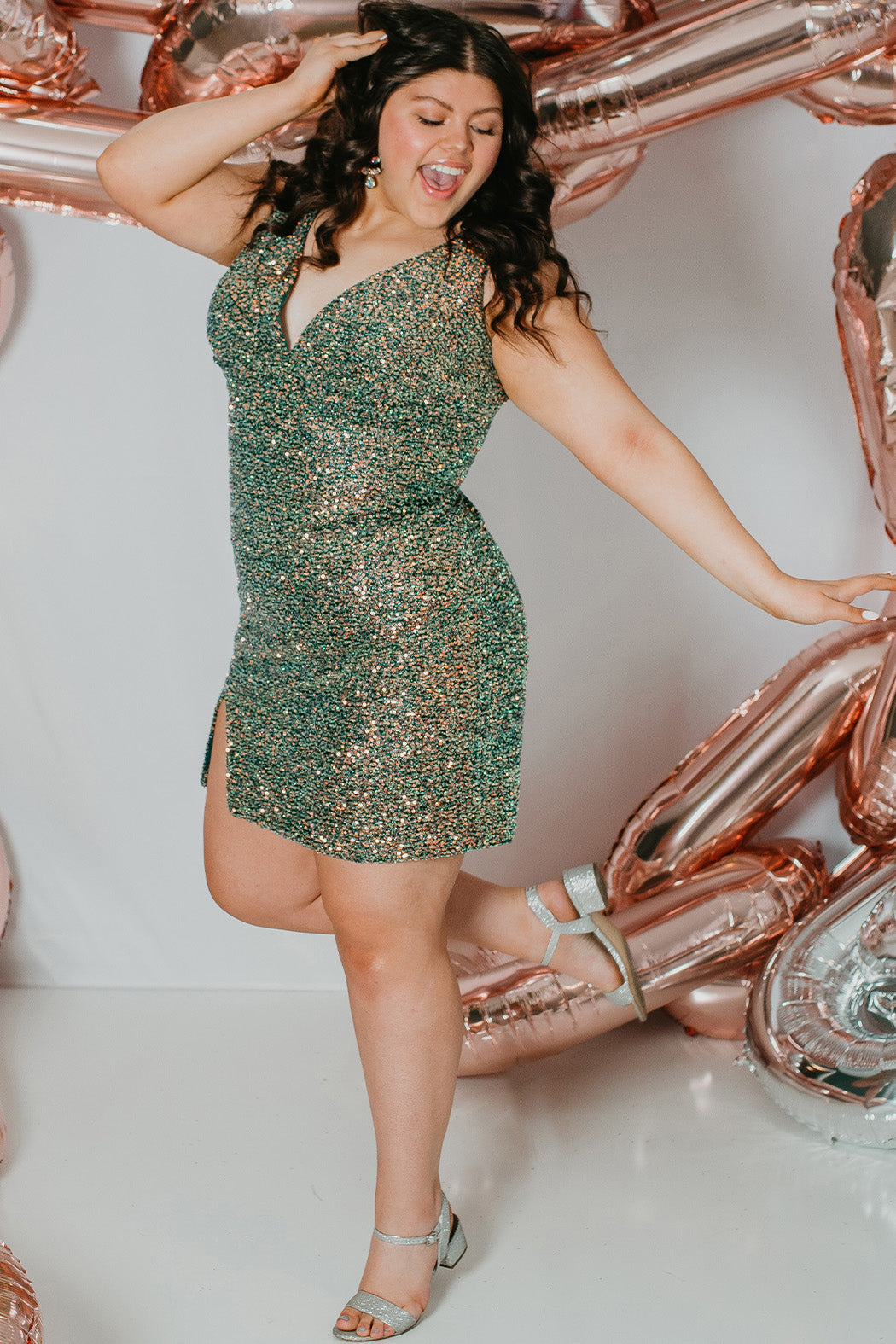 This is SC8110 in our Sydney's Closet Homecoming collection. This plus size party dress comes in blue, red, and green! This dress has bra friendly straps, empire waistline, and a v-neckline. This fitted all over sequin dress has a small slit above the right knee! This gown will catch the light for this homecoming season!