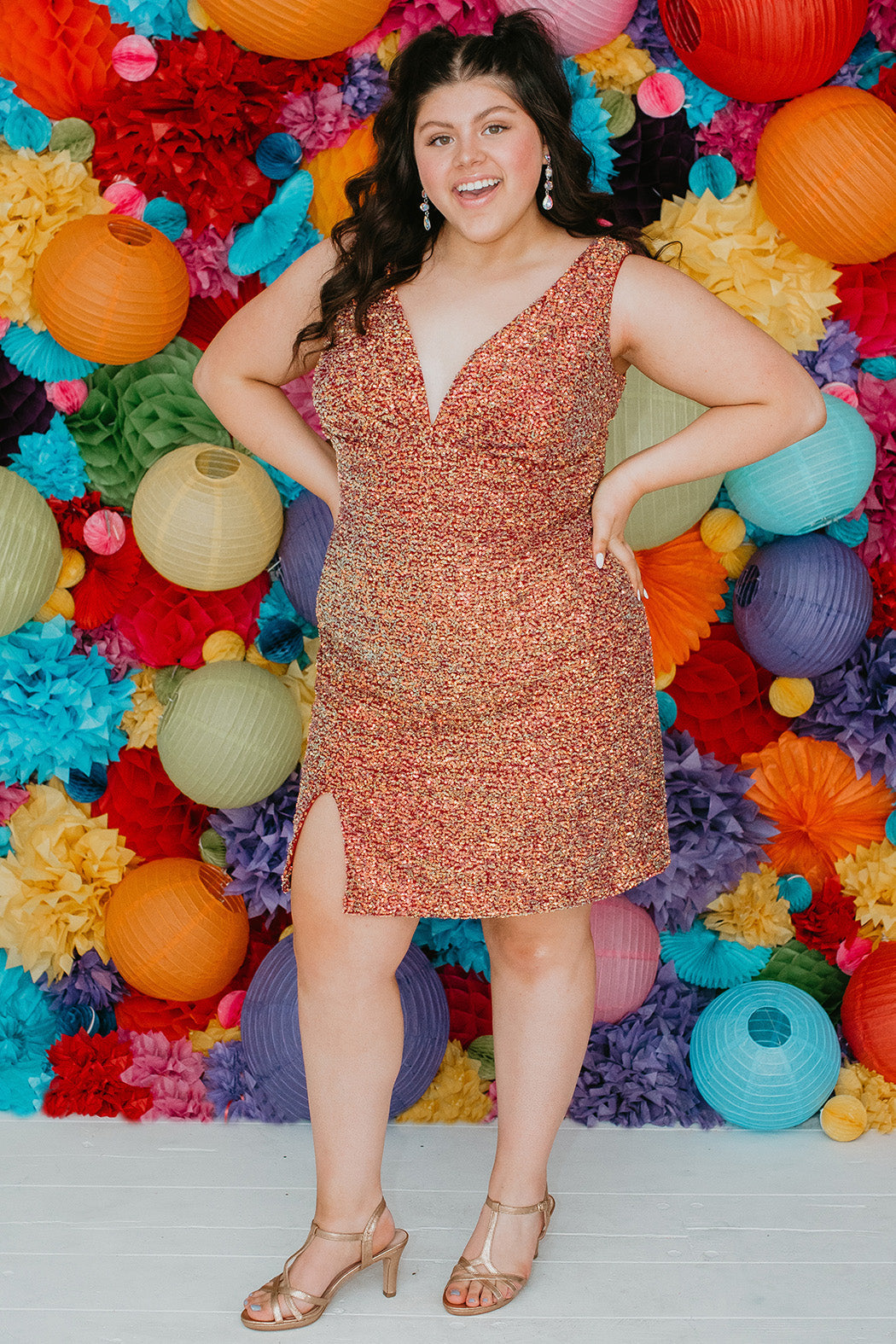 This is SC8110 in our Sydney's Closet Homecoming collection. This plus size party dress comes in blue, red, and green! This dress has bra friendly straps, empire waistline, and a v-neckline. This fitted all over sequin dress has a small slit above the right knee! This gown will catch the light for this homecoming season!