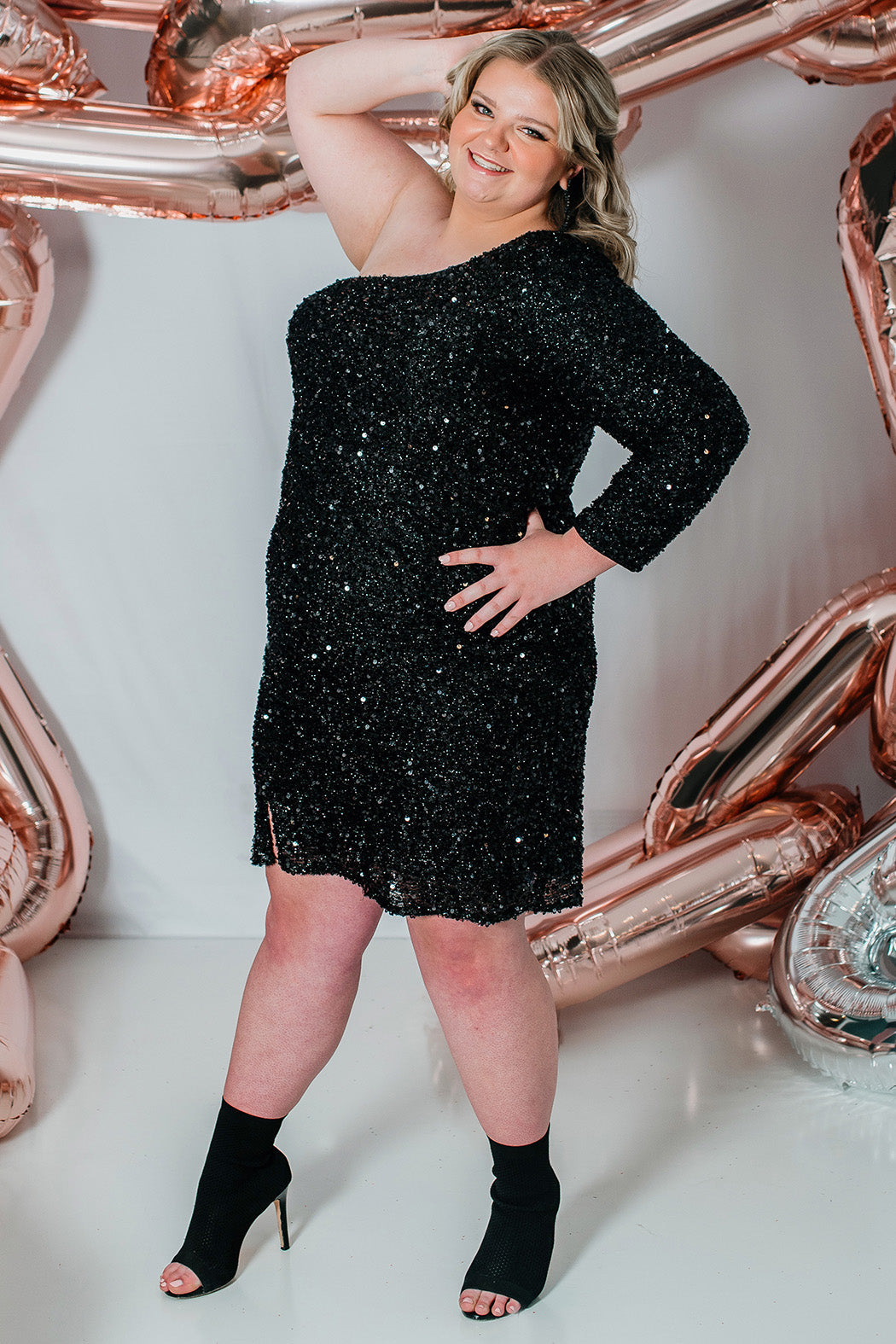 This is SC8112 in our Sydney's Closet Homecoming collection. This plus size party dress comes in green, black, white, red, and blue! This dress has one shoulder long sleeve, natural waistline, and a scoop neckline. This fitted all over sequin dress has a small slit above the right knee! This gown is set in stone for this homecoming season!