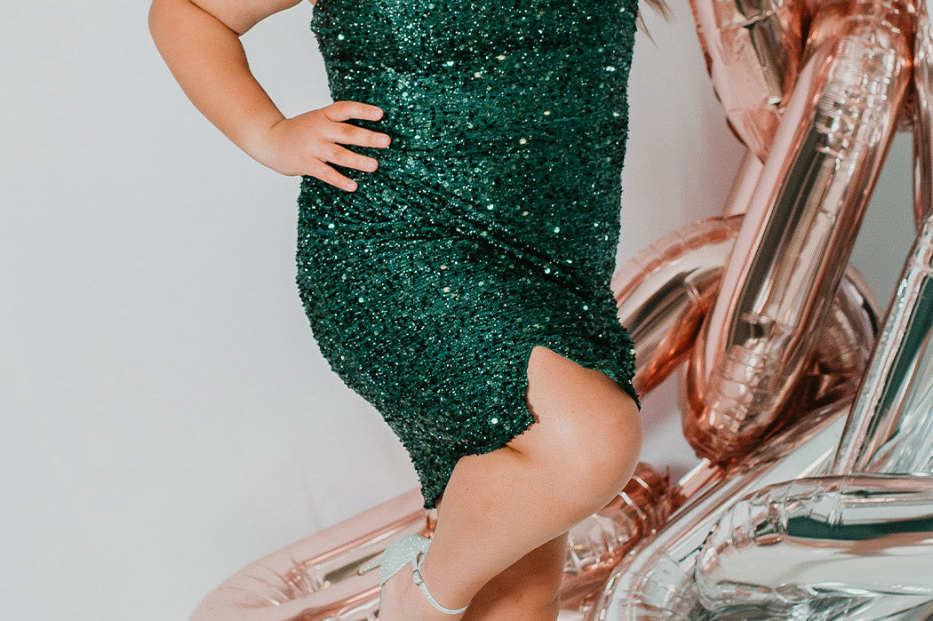 This is SC8112 in our Sydney's Closet Homecoming collection. This plus size party dress comes in green, black, white, red, and blue! This dress has one shoulder long sleeve, natural waistline, and a scoop neckline. This fitted all over sequin dress has a small slit above the right knee! This gown is set in stone for this homecoming season!