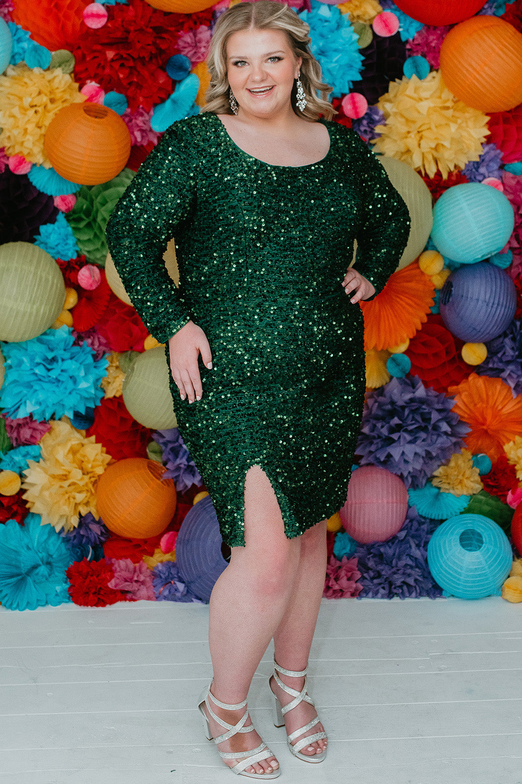Sydney's Closet Style SC8113 plus size sequin party dress with long sleeves, scoop nekcline and slit. Available in blue, red, black and forest green.