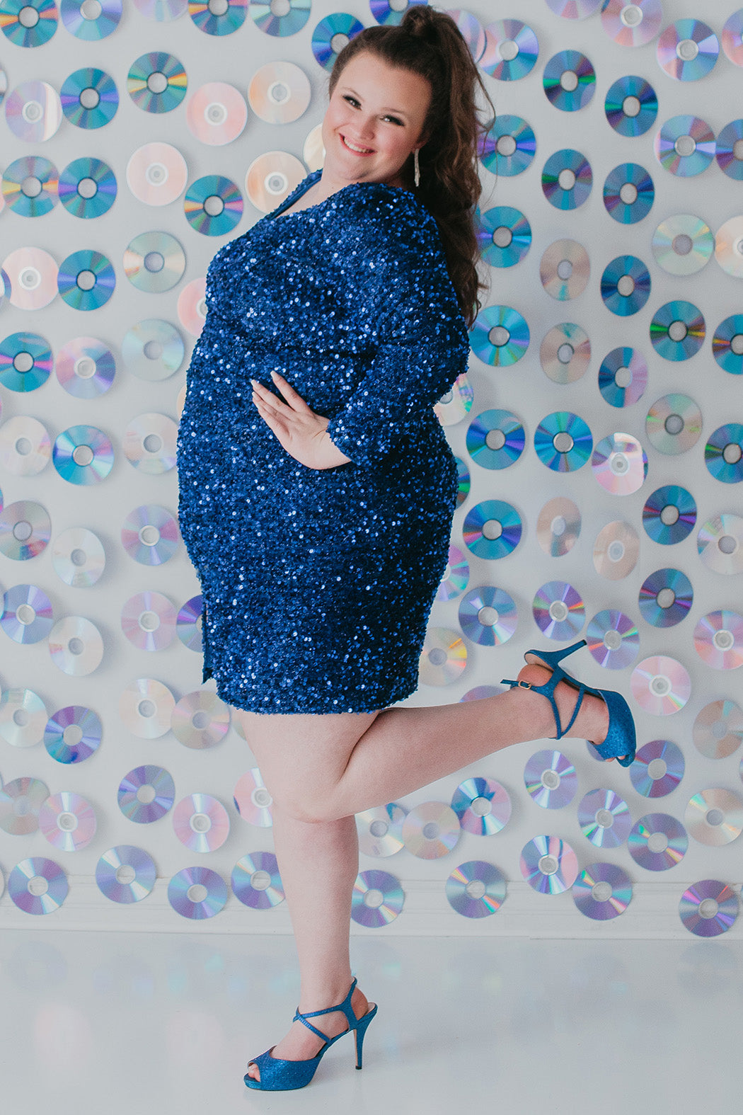 Sydney's Closet Style SC8113 plus size sequin party dress with long sleeves, scoop nekcline and slit. Available in blue, red, black and forest green.