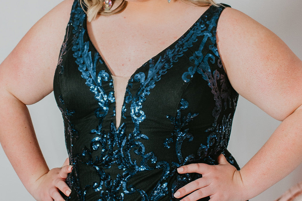 This is SC8121 in our Sydney's Closet Homecoming collection. This plus size party dress comes in black, red, and blue! This dress has bra friendly straps, a deep v-neckline with a nude mesh insert, and a natural waistline. This fitted patterned sequins gown is designed to have a mini skirt. This gown has a touch of sass for this homecoming season!