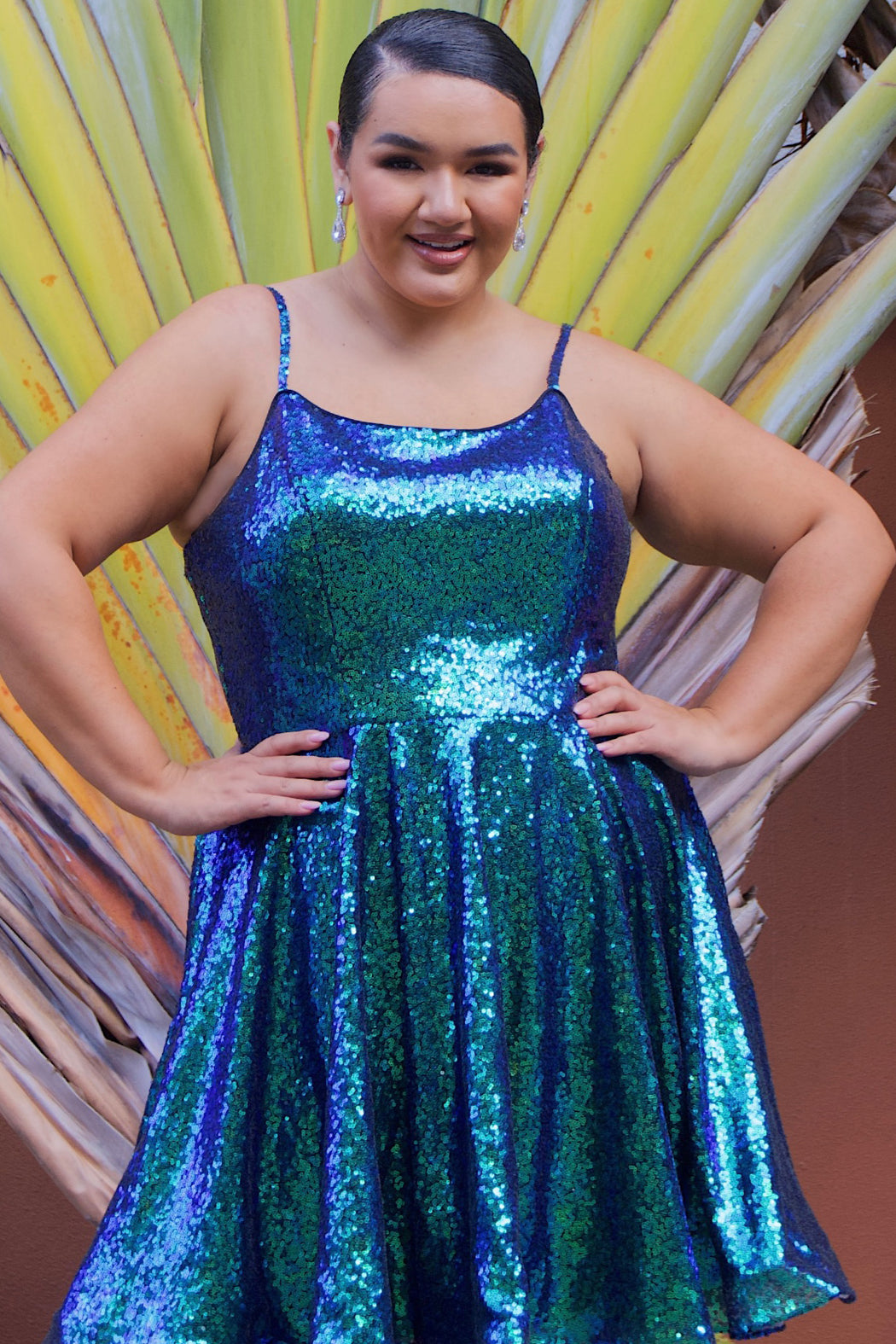 This is SC8122 in our Sydney's Closet Homecoming collection. This plus size party dress comes in white, red, blue, light blue, green, and purple! This dress has straps covered in sequins, a scoop neckline, and a natural waistline. This a-line all over sequins dress has a horsehair hem so that you can dance the night away! To make it even more spectacular, we have added pockets to make this the perfect dress for homecoming season!