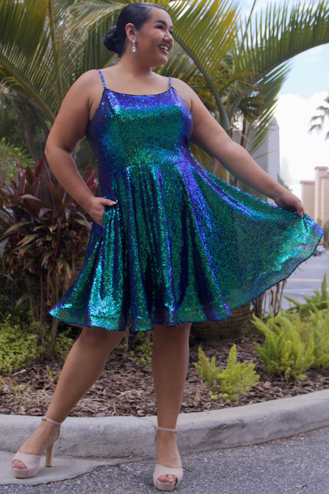 This is SC8122 in our Sydney's Closet Homecoming collection. This plus size party dress comes in white, red, blue, light blue, green, and purple! This dress has straps covered in sequins, a scoop neckline, and a natural waistline. This a-line all over sequins dress has a horsehair hem so that you can dance the night away! To make it even more spectacular, we have added pockets to make this the perfect dress for homecoming season!