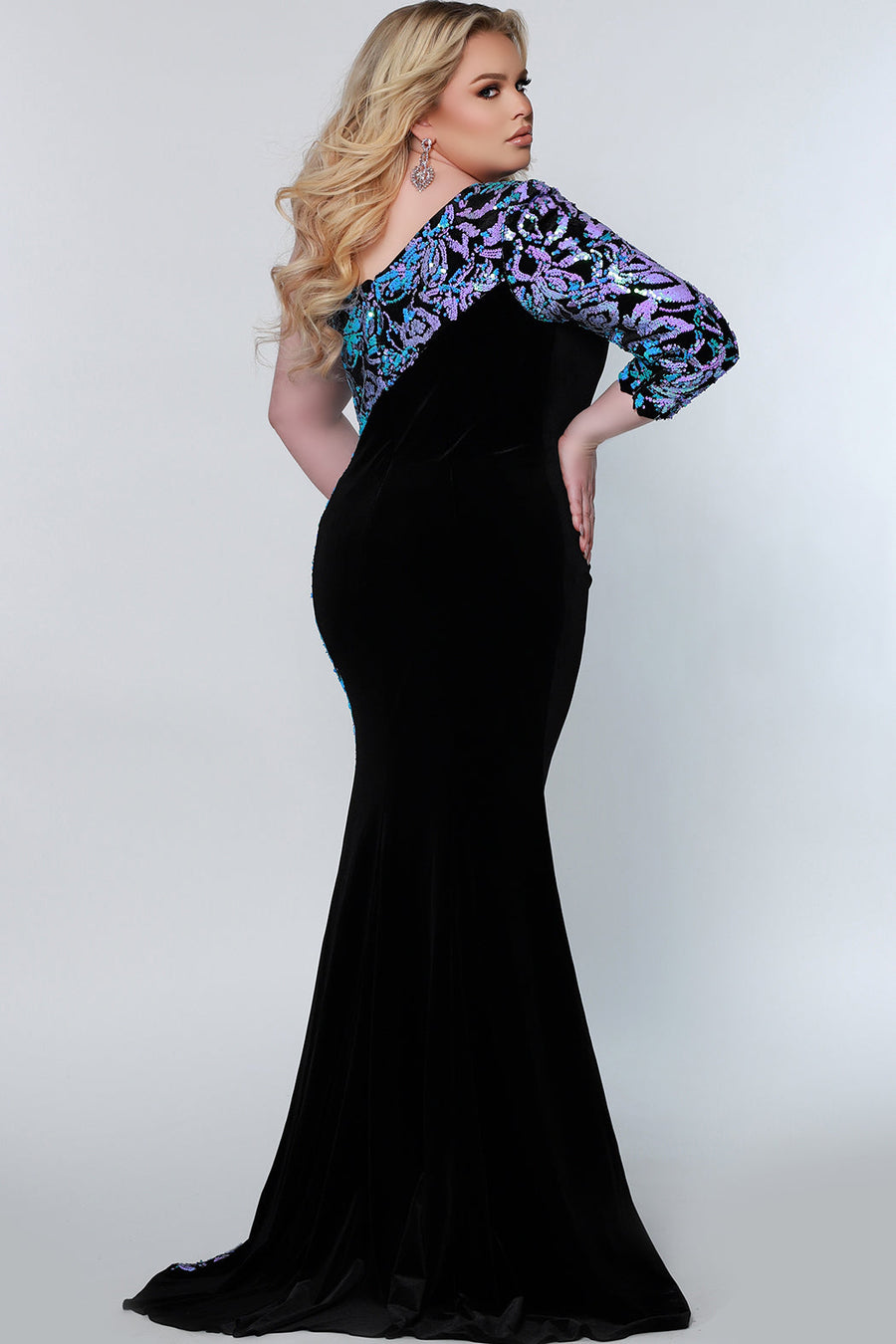 Tease Prom TE2222 back view plus size black velvet gown with double sided purple and blue sequins on the upper back leading to the single sleeve. 