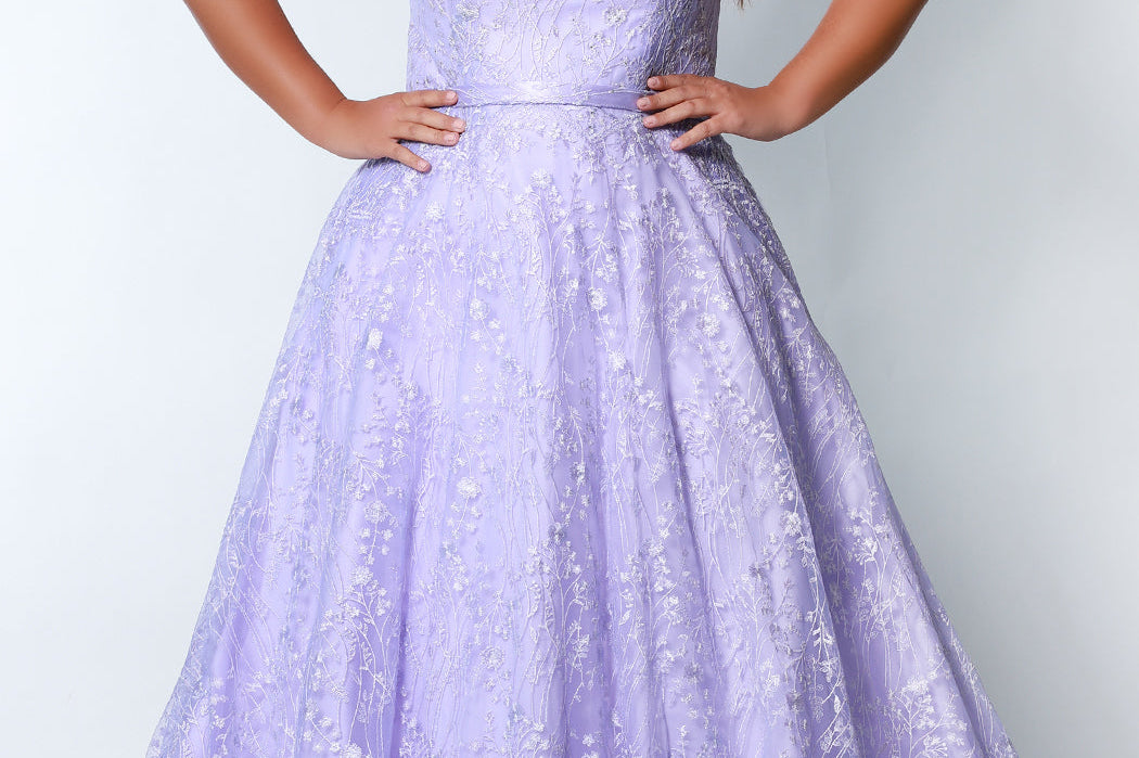 Tease Prom TE2314 light purple. Fully lined, A-line silhouette, natural waistline  and V-neckline. Ball gown skirt with pockets. Tulle with leaf lace appliques with hot fix stones. Half inch straps covered in lace. Long invisible center back zipper and a detachable self belt. 