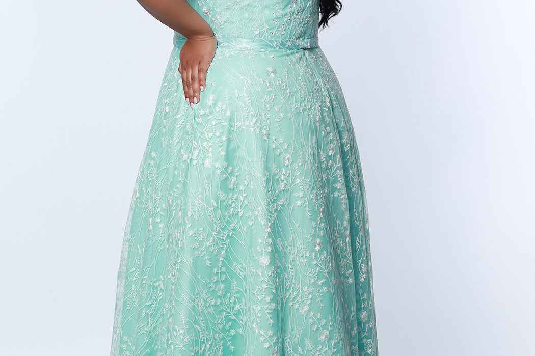 Tease Prom TE2314 Mint Green. Fully lined, A-line silhouette, natural waistline  and V-neckline.Ball gown skirt with pockets. Tulle with leaf lace appliques with hot fix stones. Half inch straps covered in lace. Long invisible center back zipper and a detachable self belt. 
