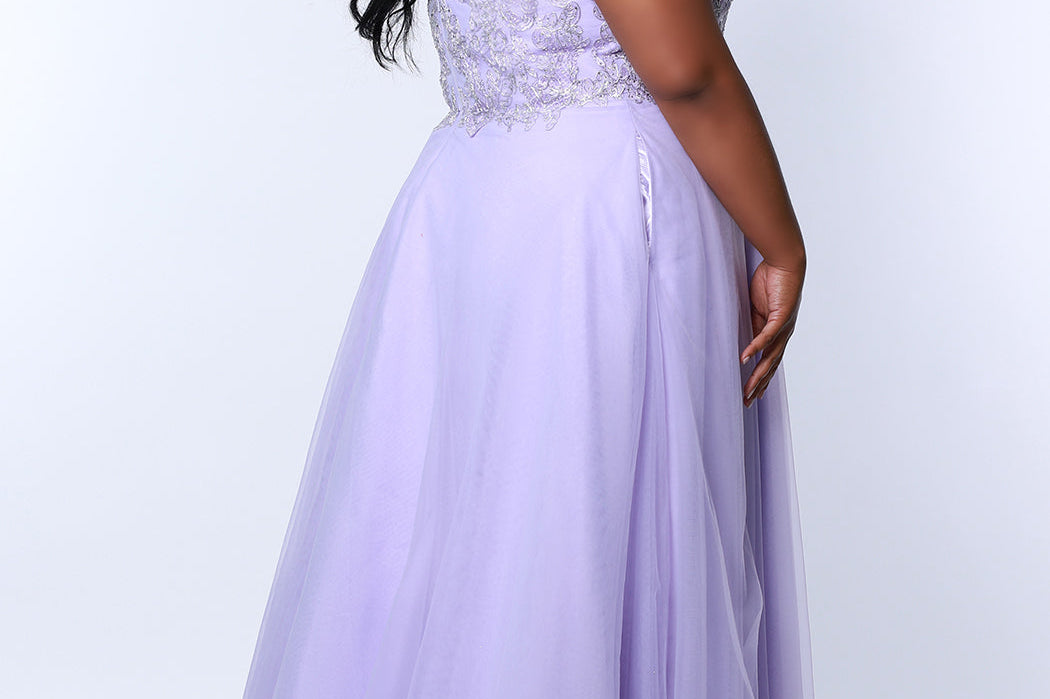 Tease Prom TE2317 Lavender purple. A-line silhouette with a natural waistline, V-neckline and V-back. Metallic lace over satin lining. Off-the-shoulder straps with elastic band, chiffon skirt with pockets and crinoline. Center back zipper. .