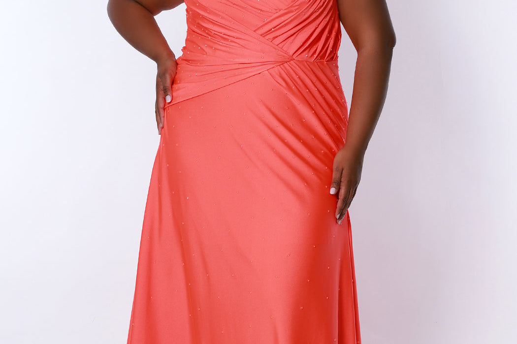 Tease Prom TE2318 Fluorescent Orange. Fit and Flare silhouette with a natural waistline and fitted skirt. V-neckline and V-bodice with pleats. Stretch lycra with hot fix stones. Sleeveless, bra-friendly straps, sweep train and a center back zipper. 