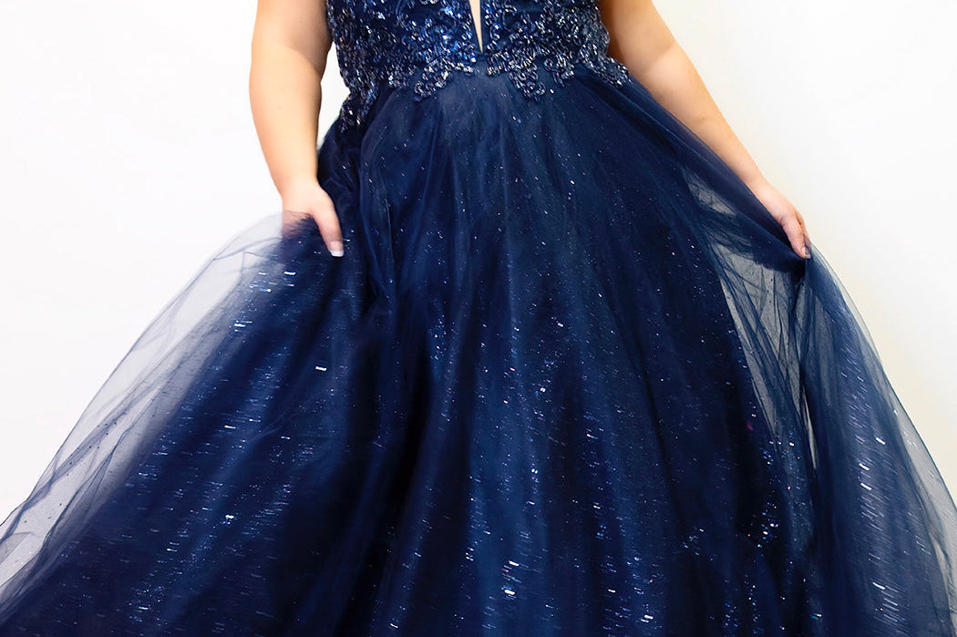 Tease Prom TE2323 Navy Blue. Ballgown silhouette with a full A-line tulle skirt. Natural waistline and a sweetheart neckline and bra-friendly straps. Heavily beaded bodice with tone-on-tone beading on lace appliques. Embroidered lace and sparkle tulle skirt with pockets. Lace-up back with modesty panel. 