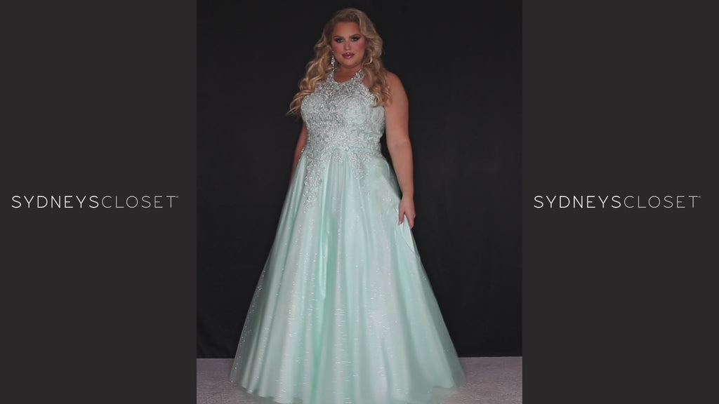 Sydney’s Closet SC7352. Full A-line silhouette with a halter neckline, a natural waistline, and an A-line skirt with crinoline, tulle and glitter tulle. Lace appliques cover the partially lined bodice and top of the skirt. Has a lace up back and modesty panel. Offered in  Ivory, Mint, Mocha, Orchid, and Peach.